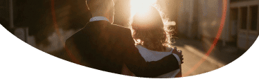 People embracing in sunset, illustrating Radical Forgiveness and healing.