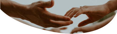 Two people's hands reaching out to each other in a friendly manner