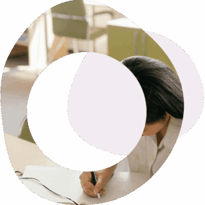 Abstract circles and image of a lady working at a desk and writing in a book