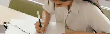 Image of a female who is studying and writing in a book for the Radical Forgiveness Coaching level 1 Program