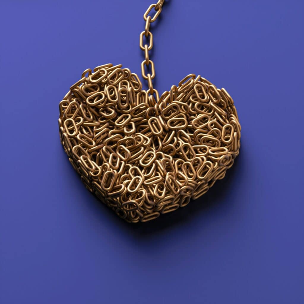 A heart shaped object made of metal chains to form the shape